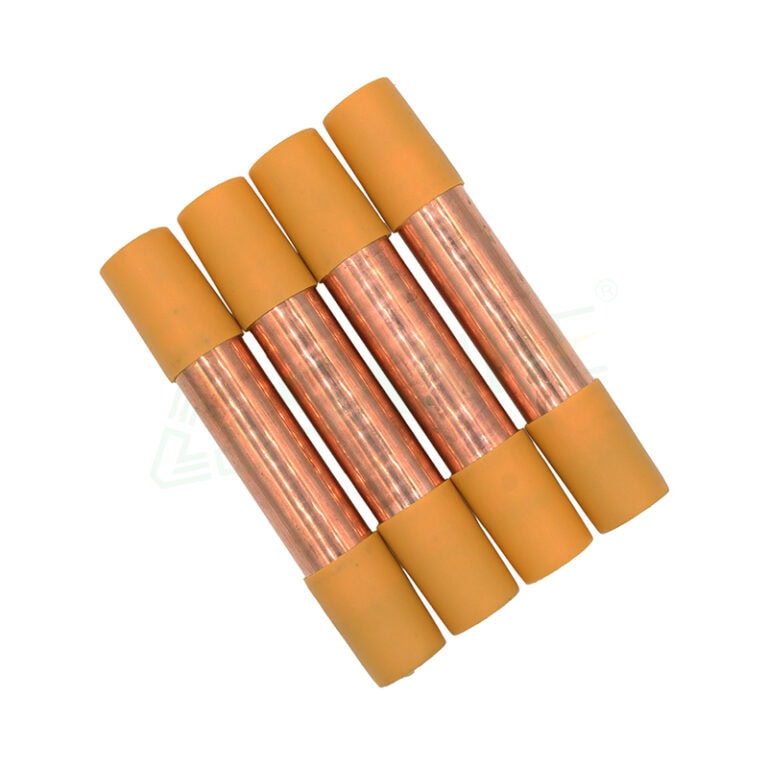 Four copper filter driers with yellow caps used in HVAC systems for moisture and debris removal from refrigerant lines.